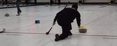 Person sliding out and releasing a curling rock